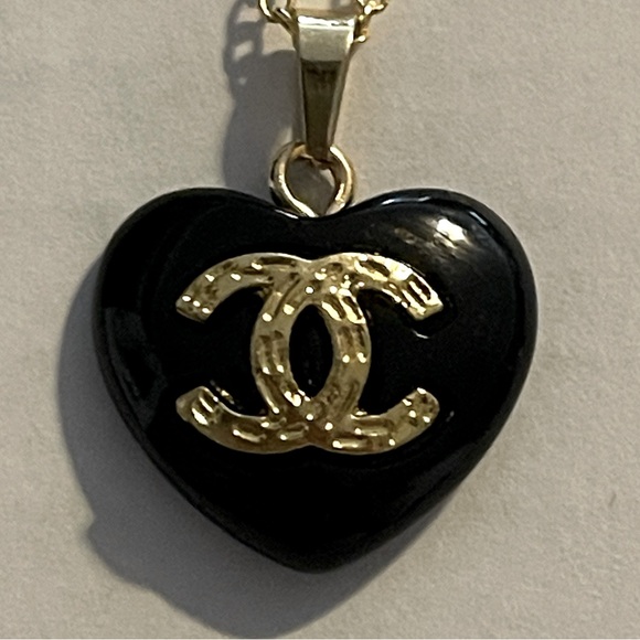 CHANEL Accessories - Channel zipper pull. Black heart with gold tone CC. Approximately sz of Quarter.